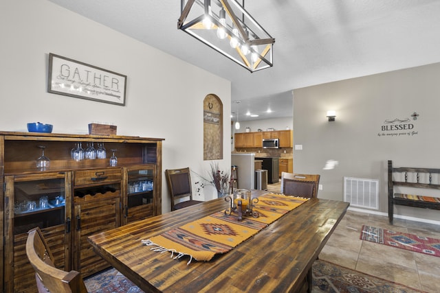 dining space featuring light tile patterned floors