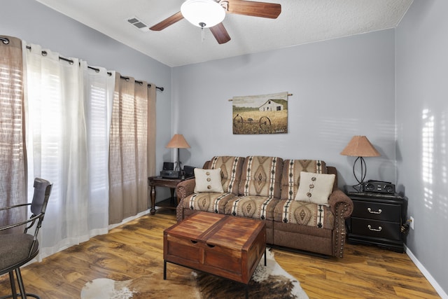 living room featuring hardwood / wood-style flooring and ceiling fan