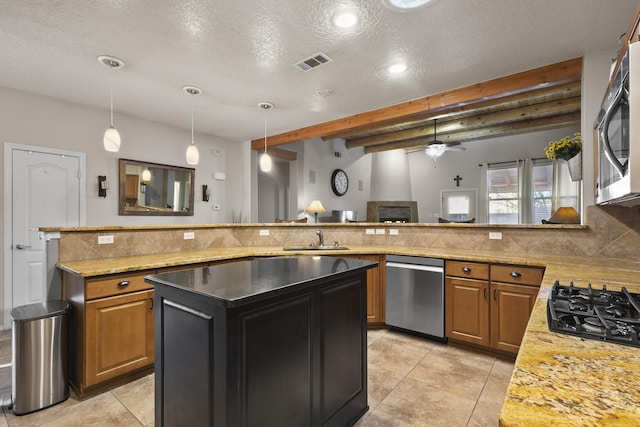 kitchen featuring stainless steel appliances, tasteful backsplash, hanging light fixtures, and sink