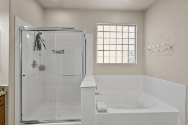 bathroom featuring vanity and separate shower and tub