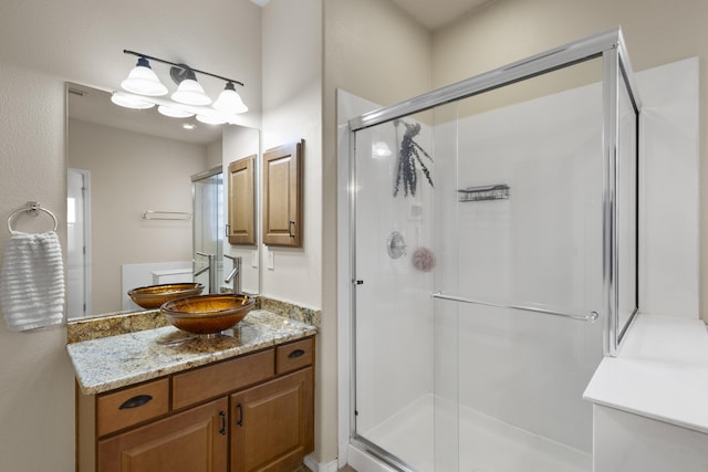 bathroom featuring vanity and an enclosed shower