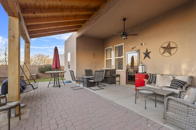 view of patio / terrace with ceiling fan and an outdoor living space