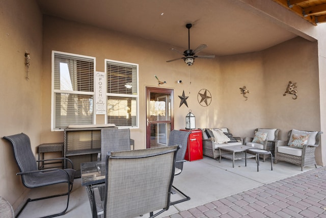 view of patio with an outdoor living space and ceiling fan