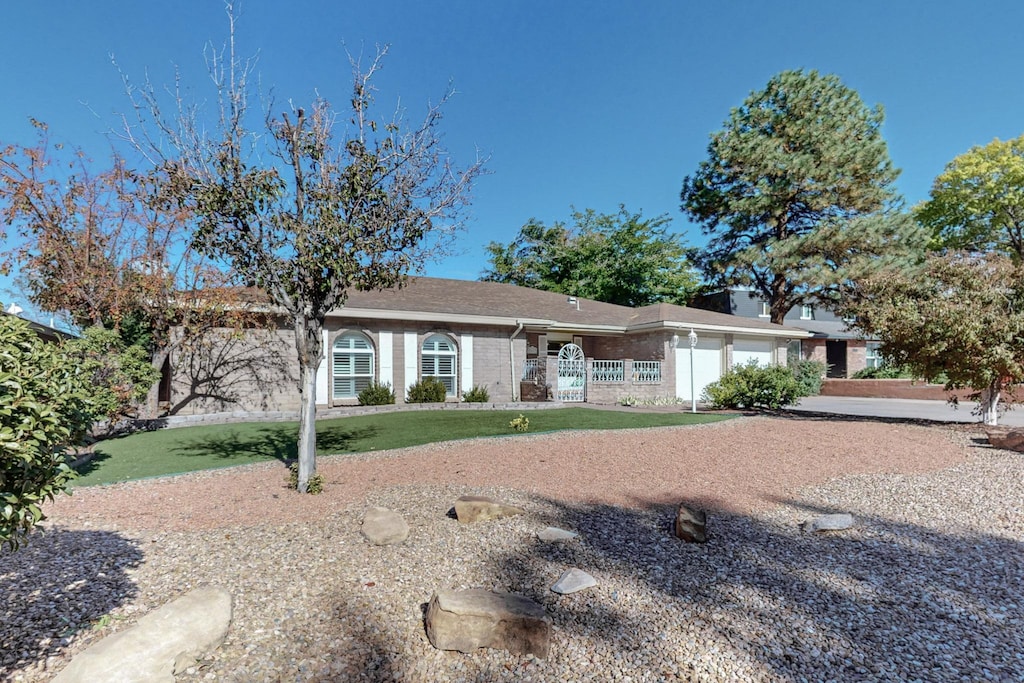 ranch-style house with a garage and a front yard