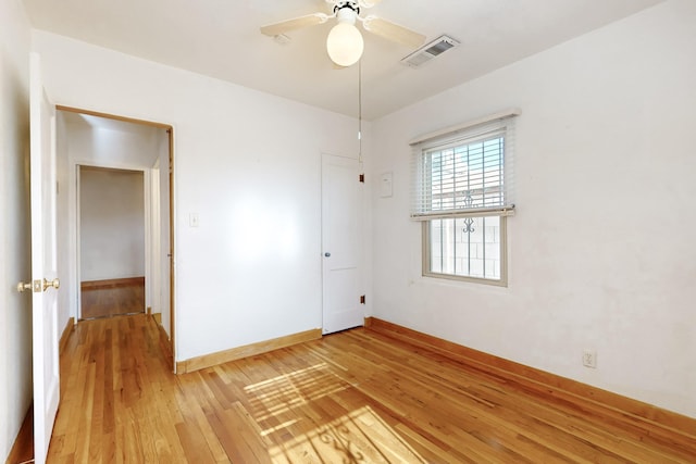 unfurnished room featuring hardwood / wood-style floors and ceiling fan