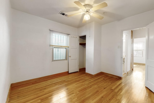 unfurnished bedroom featuring multiple windows, a closet, ceiling fan, and light hardwood / wood-style flooring