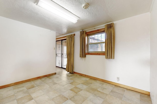 empty room featuring a textured ceiling