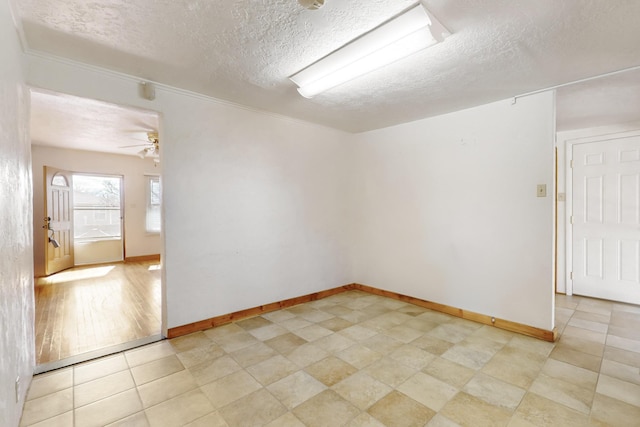 spare room featuring ceiling fan and a textured ceiling