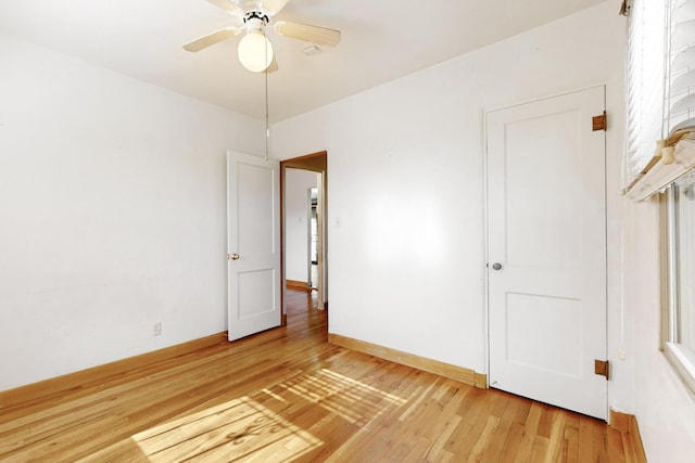 spare room with hardwood / wood-style flooring and ceiling fan