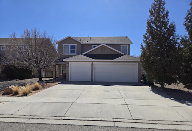 traditional-style home with concrete driveway, an attached garage, and stucco siding