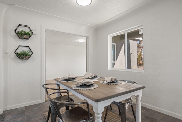 dining area featuring a textured ceiling