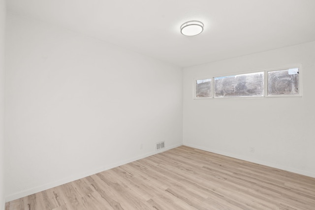 spare room featuring light hardwood / wood-style flooring