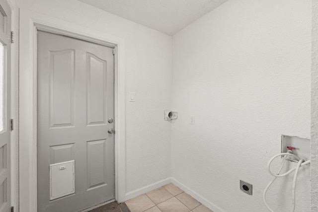 laundry room featuring light tile patterned floors, hookup for a washing machine, and hookup for an electric dryer