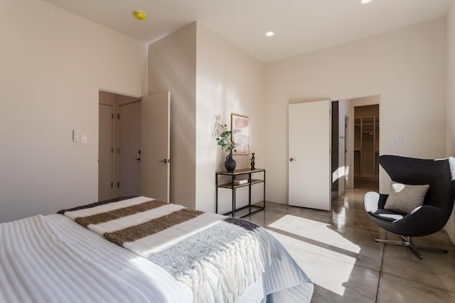 bedroom with a closet, a towering ceiling, and a spacious closet