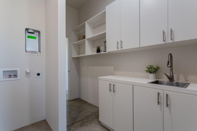 washroom with cabinets, sink, hookup for an electric dryer, and hookup for a washing machine