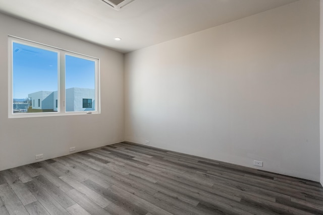 spare room featuring wood-type flooring