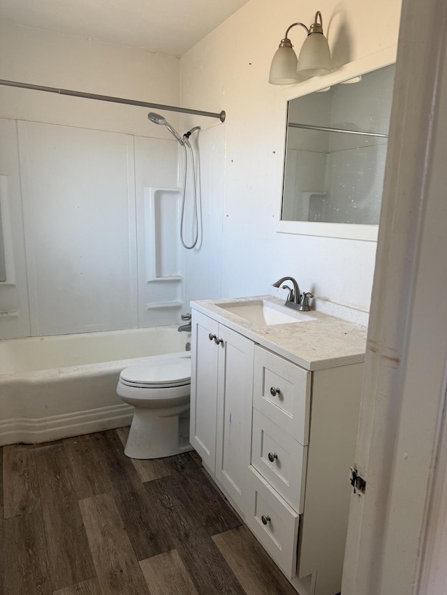 full bathroom featuring toilet, bathtub / shower combination, wood finished floors, and vanity