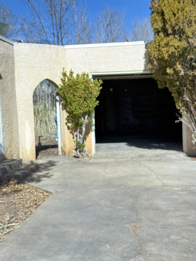exterior space with driveway and stucco siding