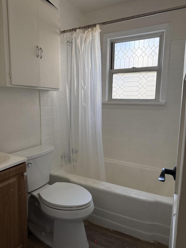 full bathroom featuring toilet, shower / bath combo, wood finished floors, and vanity