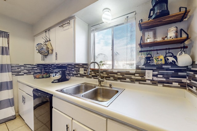 kitchen featuring white cabinetry, sink, light tile patterned floors, and black dishwasher