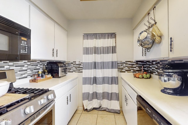 kitchen with light tile patterned flooring, white cabinets, tasteful backsplash, and black appliances