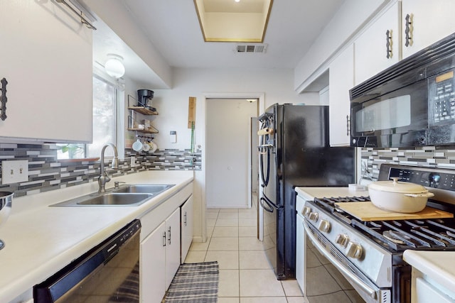 kitchen featuring sink, black appliances, white cabinets, and light tile patterned flooring