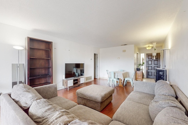 living room with hardwood / wood-style flooring and a textured ceiling