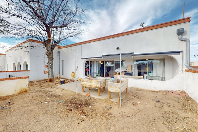 rear view of house featuring a patio