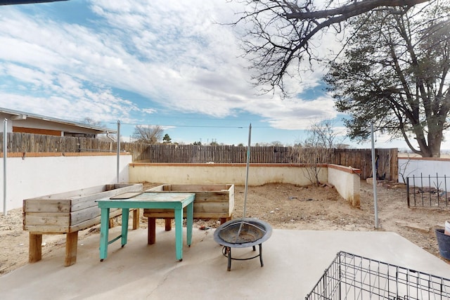 view of patio / terrace with an outdoor fire pit