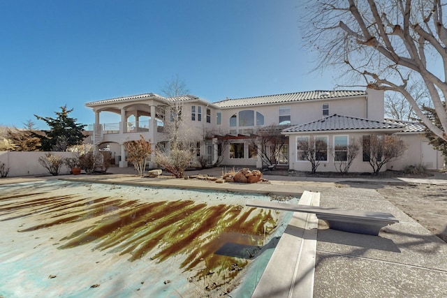 rear view of property with a balcony