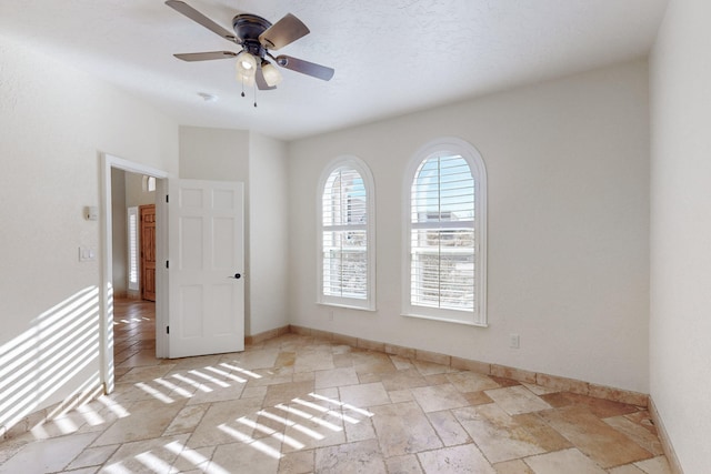 spare room with ceiling fan