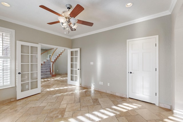 unfurnished room featuring french doors, ceiling fan, and crown molding