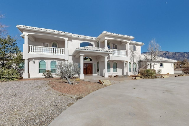 mediterranean / spanish-style house featuring a balcony