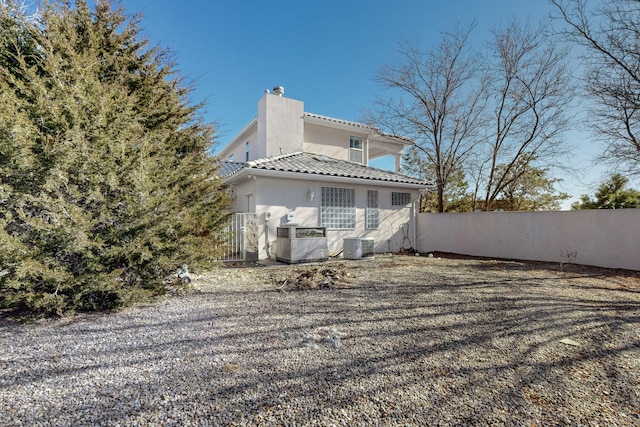 rear view of house featuring cooling unit