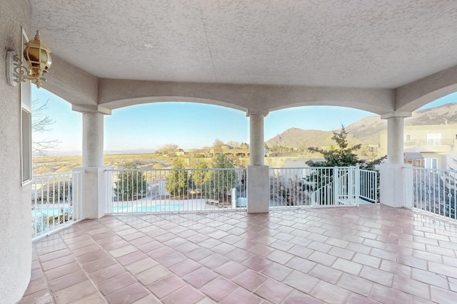 view of patio featuring a mountain view and a community pool