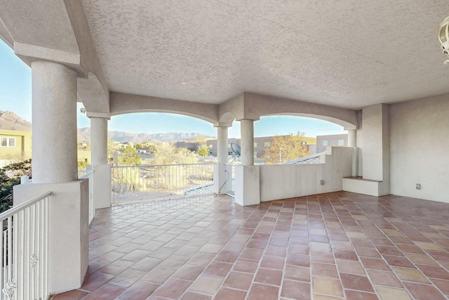 view of patio featuring a balcony and a mountain view