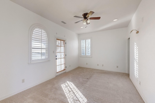 carpeted empty room featuring ceiling fan