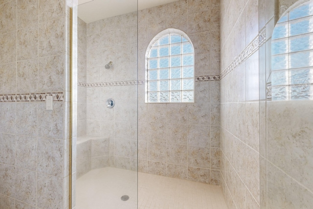 bathroom with a tile shower