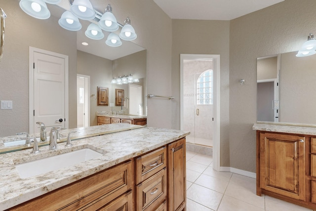 bathroom featuring walk in shower, vanity, and tile patterned flooring