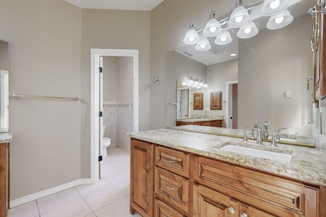 bathroom with tile patterned flooring, vanity, and toilet