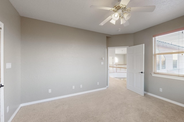 unfurnished bedroom with light carpet and ceiling fan