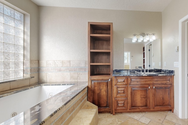 bathroom with vanity and tiled bath