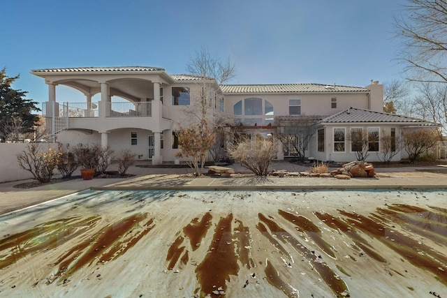 rear view of house featuring a balcony