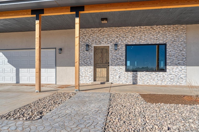 view of exterior entry with a garage