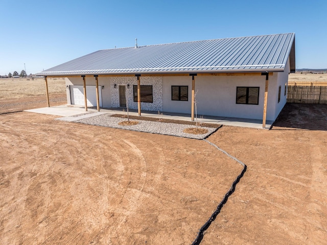 rear view of property featuring a patio