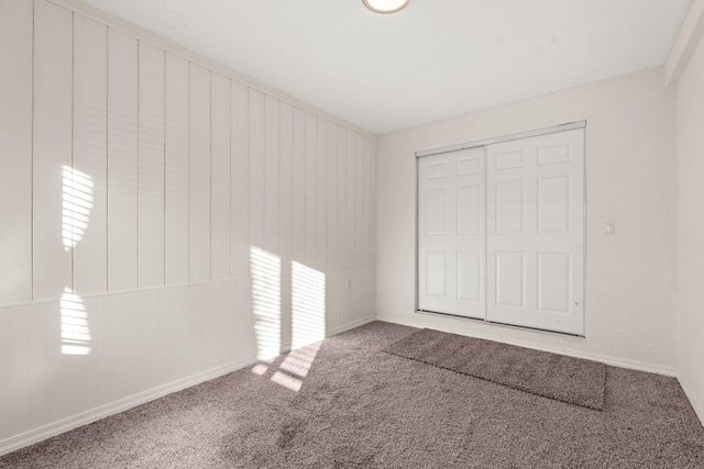 unfurnished bedroom featuring carpet floors and a closet