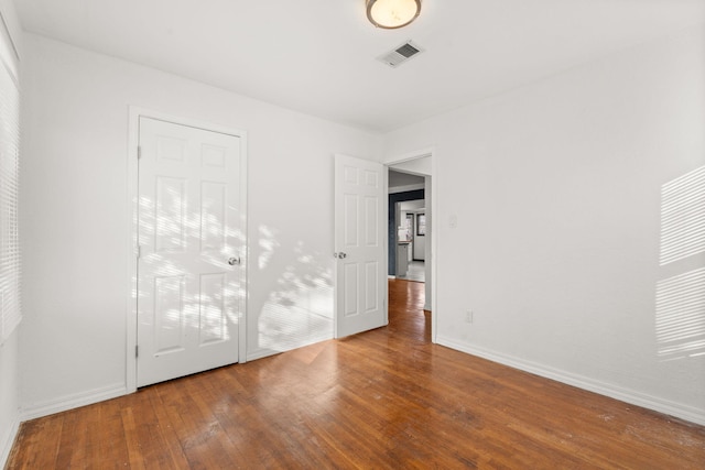 unfurnished bedroom with hardwood / wood-style floors