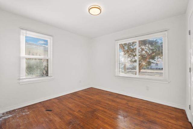 empty room with hardwood / wood-style floors