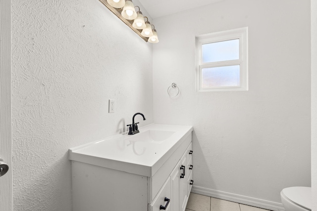 bathroom featuring vanity, tile patterned flooring, and toilet