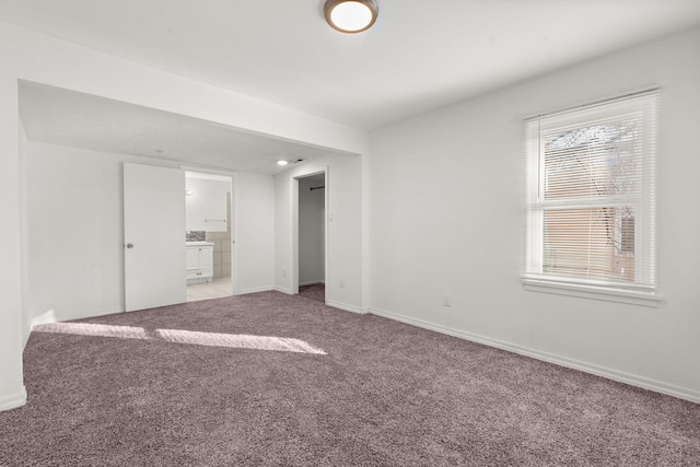 unfurnished room featuring light carpet